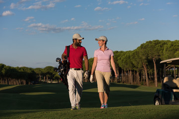 couple walking on golf course