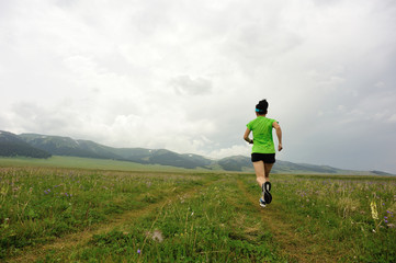 healthy young woman trail runner running on beautiful trail