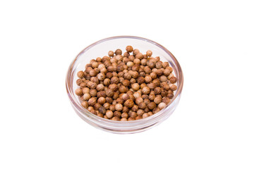 Coriander seeds on a bowl on a white background