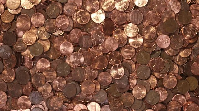 Spiraling US pennies coin background with zoom in.