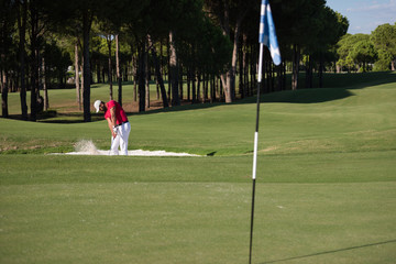 golfer hitting a sand bunker shot