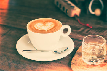 Vintage filtered,white coffee cup with heart shape latte art on