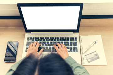 woman shopping online with laptop and credit card with work space