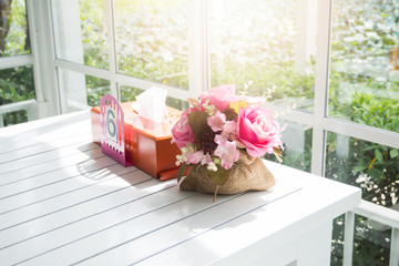 Bouquet of beautiful artificial flowers on white wooden table in
