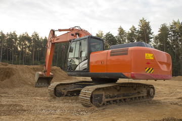 a large excavator is preparing the site for construction of a ne