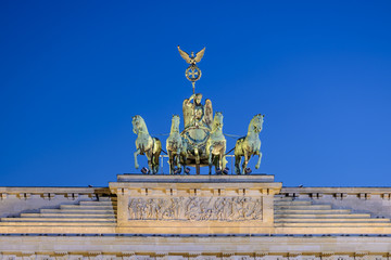 the illuminated bronze sculpture Quadriga on the Brandenburg Gate (Brandenburger Tor) in the evening, Berlin, Germany, Europe