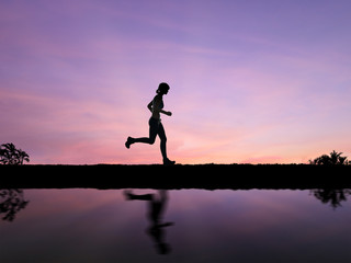 silhouette woman running on twilight background