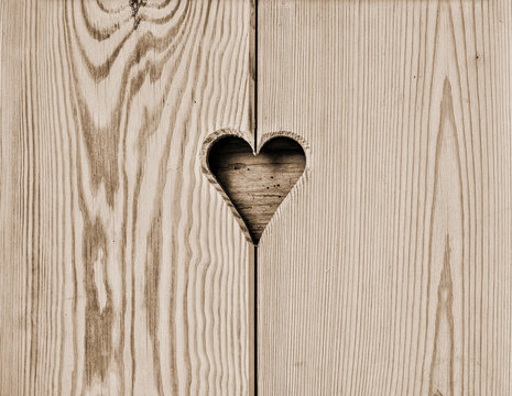heart in a wooden wall background, sepia filtered style