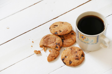 Cookies and coffee on white wooden palette