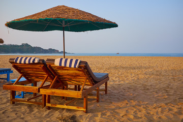 empty beach chairs on a tropical beach