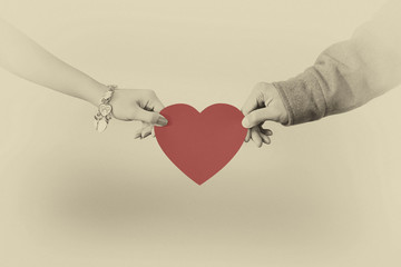 Man and woman hands holding a heart shape
