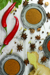 Colorful Indian spices on white wooden table top
