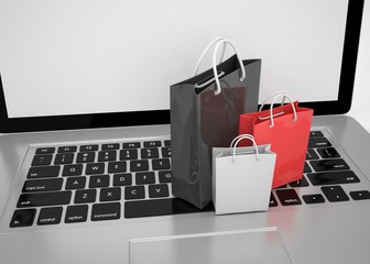 laptop and  shopping pags on white background. 3d rendering.