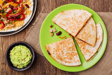 Quesadilla with chicken, served with guacamole or salsa sauce.