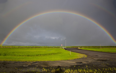 Double rainbow over sugarcane fields and Bruce Highway, Far North Queensland, Australia