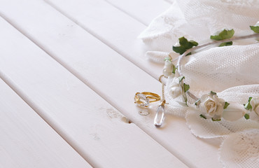 Gold ring and necklace and white floral tiara © tomertu
