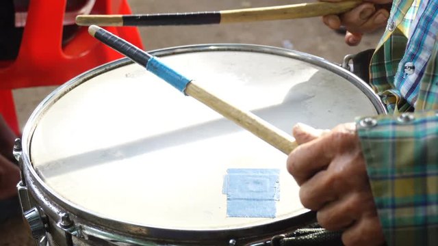 A man playing the drum with the bands
