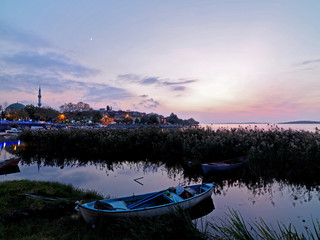 Fototapeta na wymiar Sunset time on the Lake with fisherman boats