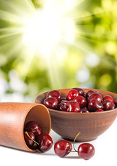 image of cherry in a bow on a green background closeup