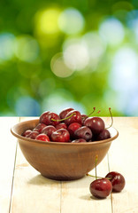 image of cherry in a bow on a green background closeup