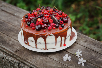 Cake with chocolate, berries and biscuits