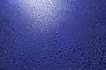 image of blue surface with drops close-up