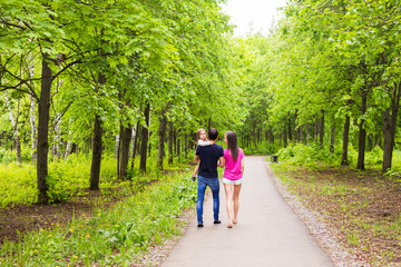 Fototapeta premium Happy young family walking in green nature.