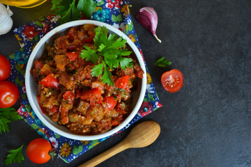 vegetable stew of eggplant on a black background, grilled vegeta