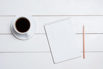 Blank empty notepad with coffee on table
