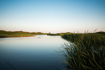 Lake hazard at the golf course at sunset