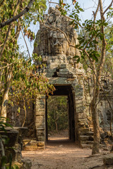 Gate of Angkor Wat temple in rain forest