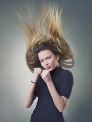 Obraz premium Jumping girl with flying ombre hair and clenched fists