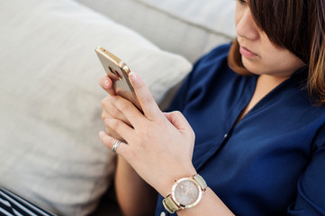 Women using a smartphone in a shop, soft focus.