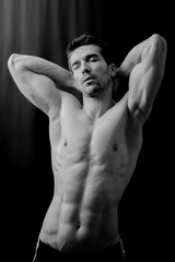 Man posing with eyes closed in black and white shot 