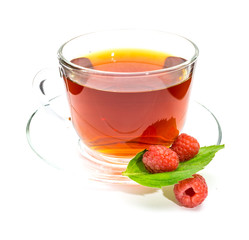 Transparent cup of black tea and raspberry