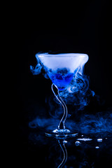 blue cocktail with splash and ice vapor