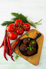 Grilled meatballs with chili pepper  served in cast iron skillet