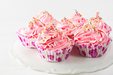 Pink birthday cupcakes  on cake stand