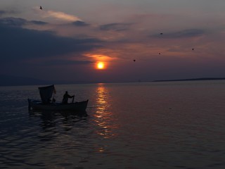 Fisherman and ships on the Golyazi lake at Bursa city, Turkey