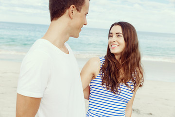 Romantic young couple standing on the beach