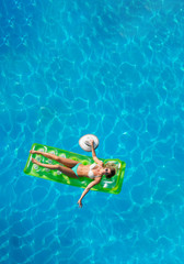 Beautiful young woman in bikini Relaxing in a pool