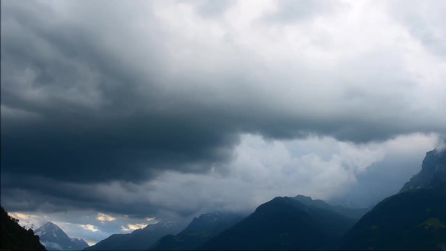 Dangerous clouds on the sky. Thunderstorm over the mountain. Swiss Alps. Uri.