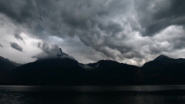 Dangerous clouds on the sky. Thunderstorm over the mountain. Swiss Alps. Uri.