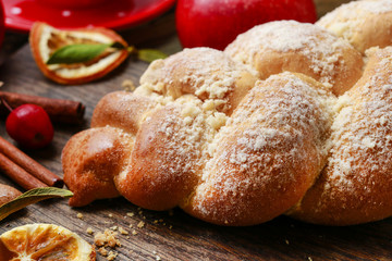 Festive bread on the table. Red christmas decorations