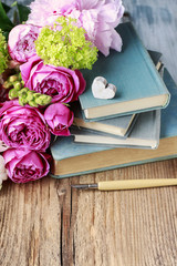 Old books and bouquet of flowers