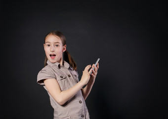 Portrait of surprised girl touch screen on mobile phone