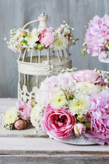 Floral arrangement with pink peonies, tiny roses