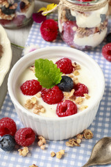 Breakfast table: bowl of yogurt with muesli and fresh fruits