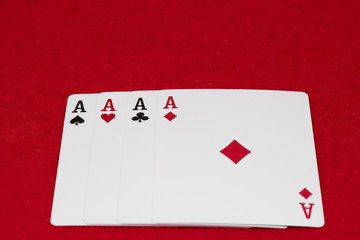 Four aces - A winning poker hand of four aces playing cards suits on RED.
