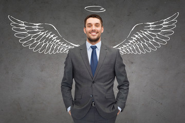 smiling businessman with angel wings and nimbus